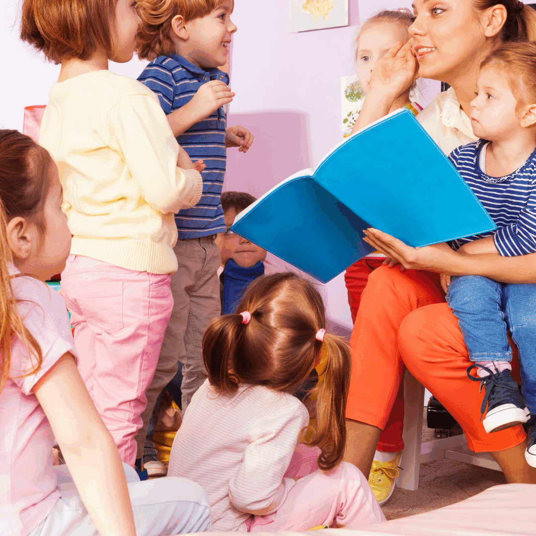 Teacher reading to attentive children group