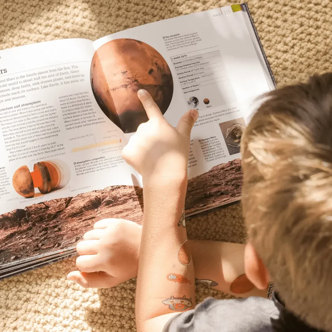 Child reading a space book